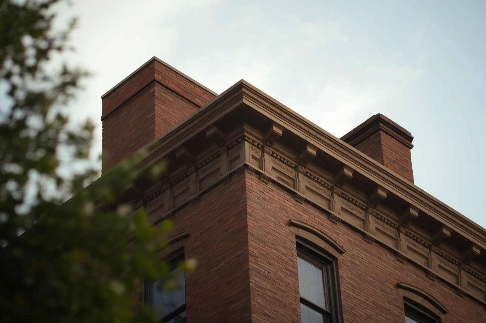 Cornice, parapet and chimney detail on a pre-war apartment building in Flatbush, Brooklyn